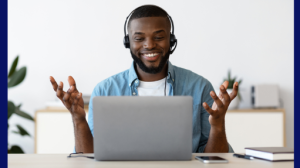 online therapy 12 A man raises his hands to express joy as he looks at the screen of a laptop computer